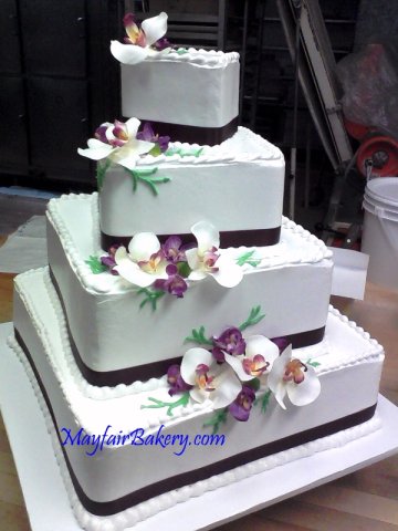 4 tier square with orchids and black ribbon